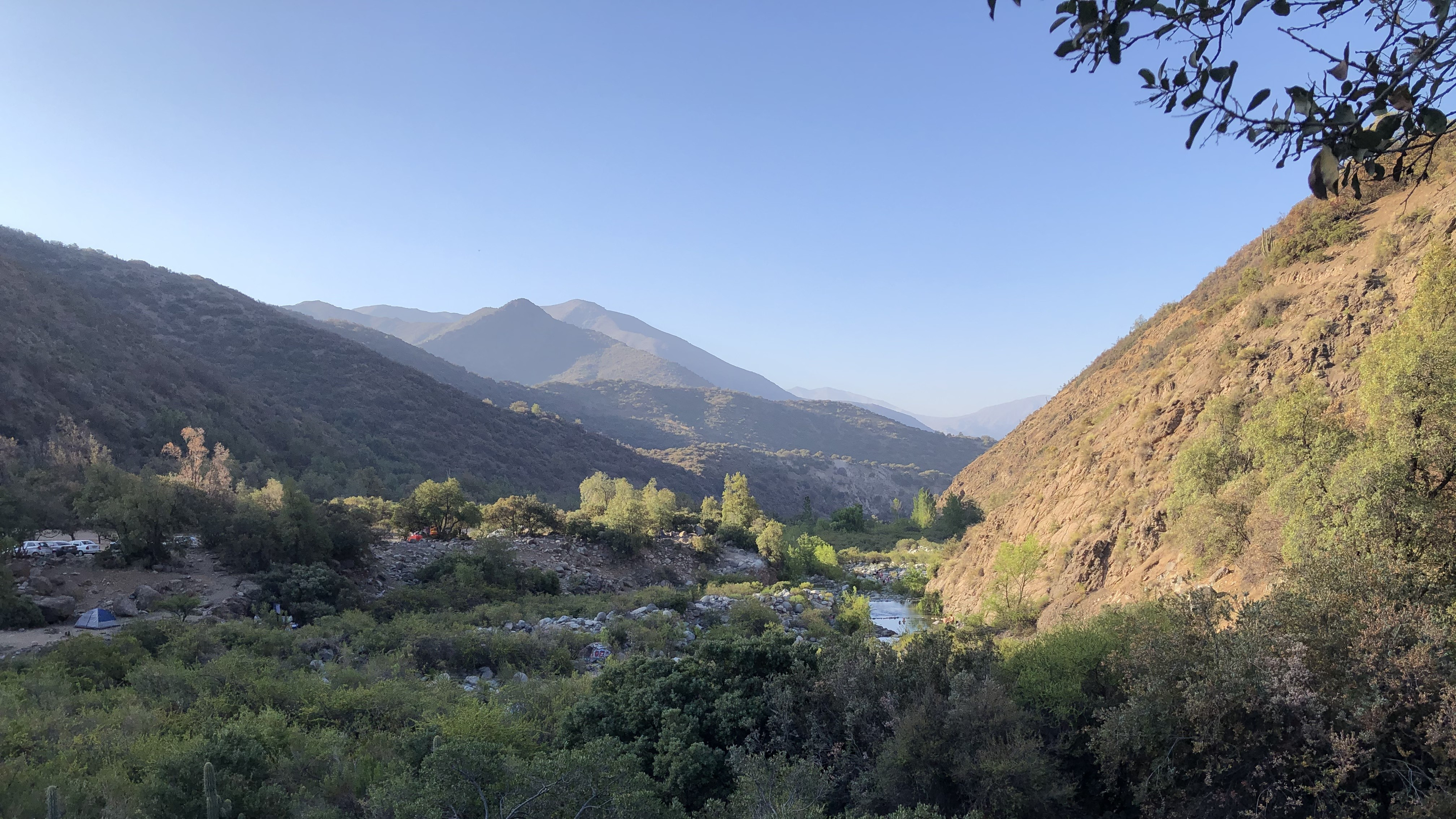 A river valley campsite framed by dry Andean foothills near Santiago.